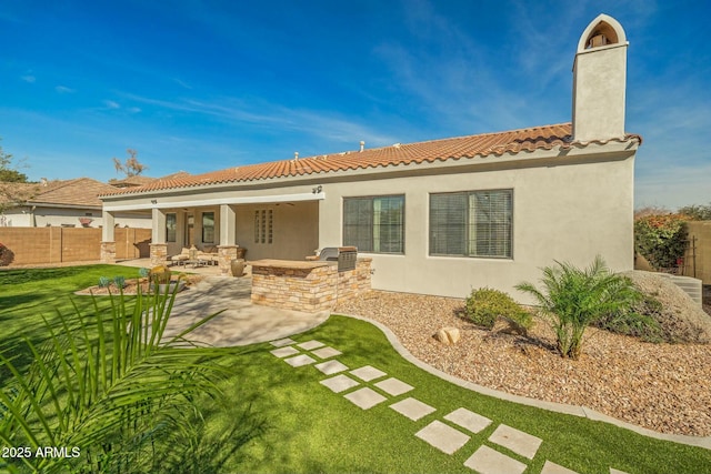 891 W Palo Brea Dr, Litchfield Park, AZ 85340 - rear view of property with fence, a patio, a chimney, stucco siding, and an outdoor kitchen