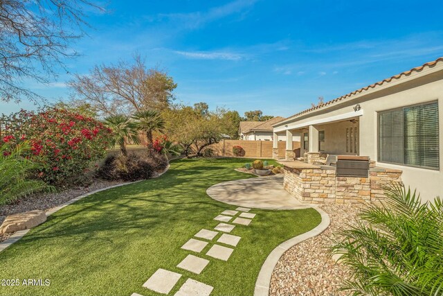 891 W Palo Brea Dr, Litchfield Park, AZ 85340 - view of yard with an outdoor kitchen, a fenced backyard, and a patio area