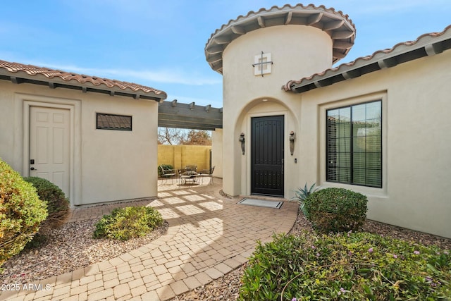 891 W Palo Brea Dr, Litchfield Park, AZ 85340 - property entrance with a pergola, a patio, a tiled roof, and stucco siding