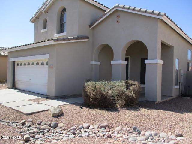 mediterranean / spanish home with a tile roof and stucco siding