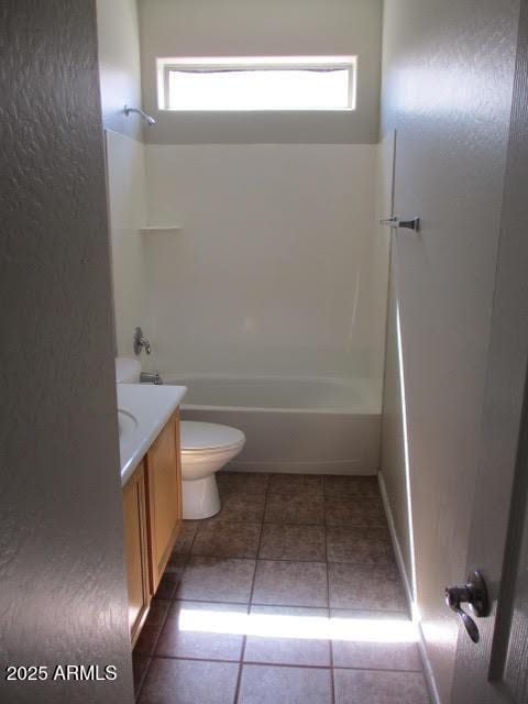 bathroom featuring washtub / shower combination, vanity, toilet, and tile patterned floors