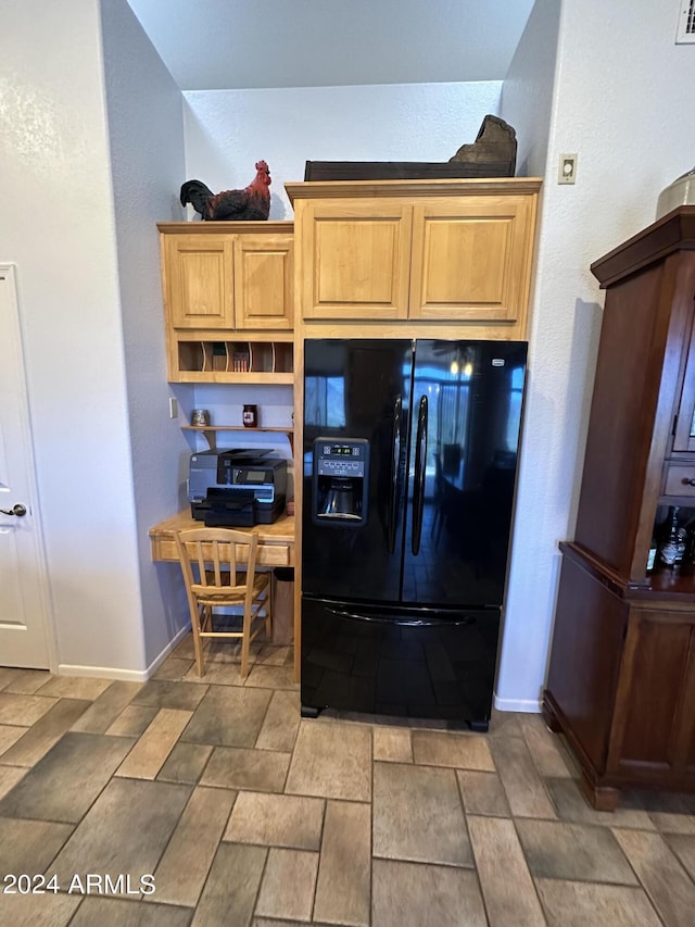 kitchen with black refrigerator with ice dispenser