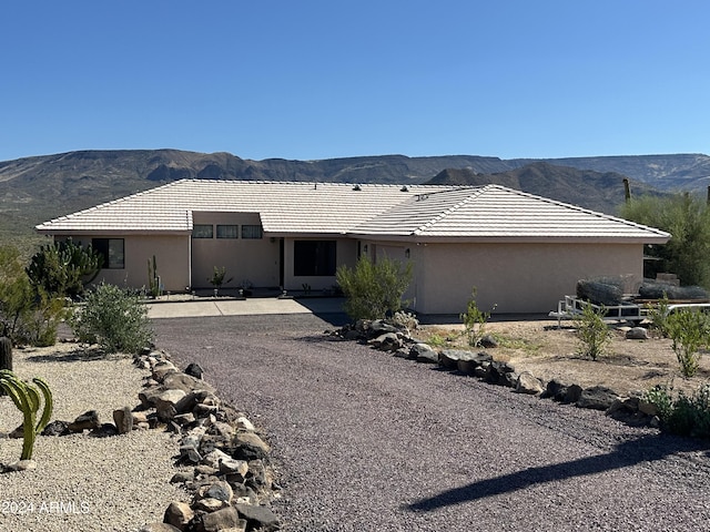 view of front of home featuring a mountain view and a patio area