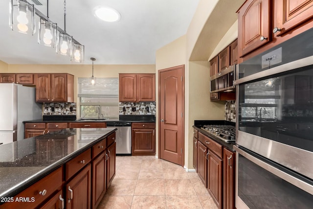 kitchen featuring light tile patterned floors, stainless steel appliances, tasteful backsplash, pendant lighting, and sink