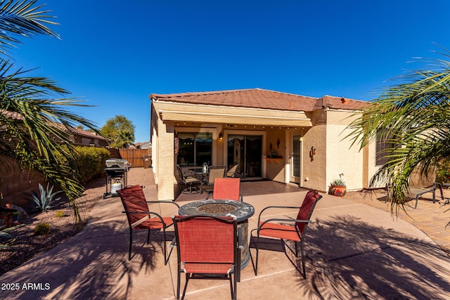 back of house with a patio and a fire pit