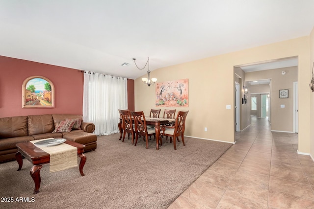 living room with light carpet, an inviting chandelier, and plenty of natural light