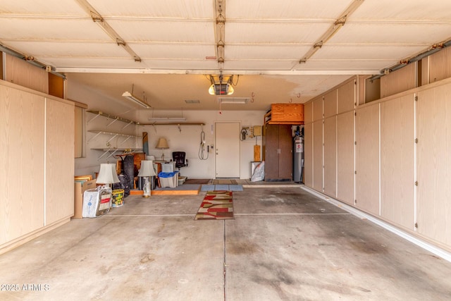 garage featuring a garage door opener and electric water heater