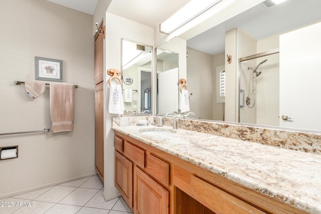 bathroom featuring tile patterned floors, vanity, and a shower