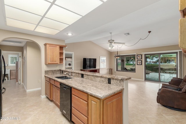 kitchen featuring sink, ceiling fan, black dishwasher, light stone counters, and vaulted ceiling