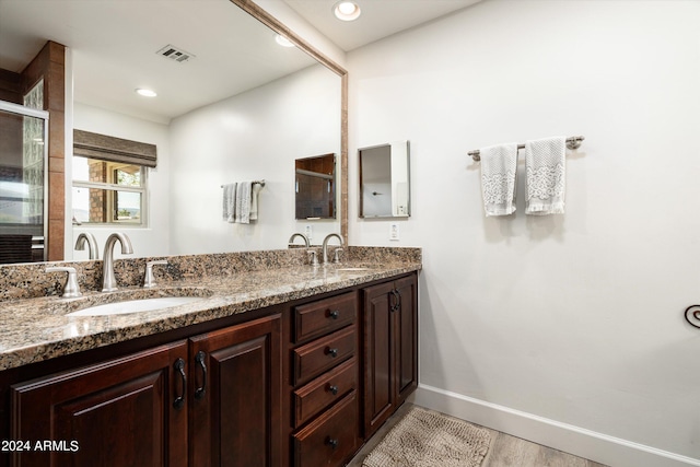 bathroom with wood-type flooring and vanity