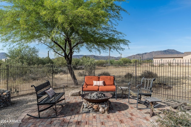 view of patio / terrace with an outdoor fire pit and a mountain view