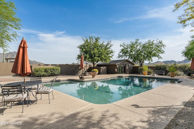 view of pool with a mountain view and a patio area