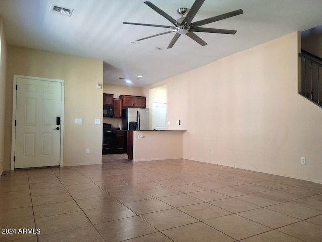 unfurnished living room featuring light tile patterned flooring and ceiling fan