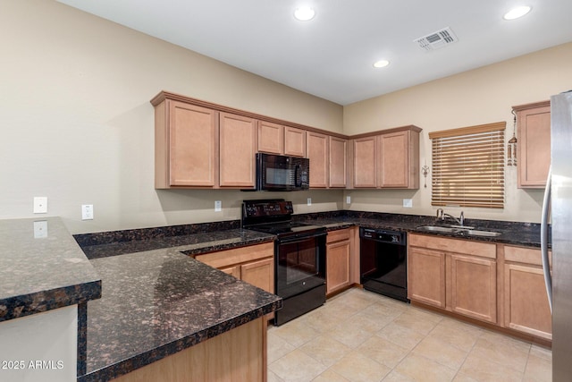 kitchen featuring black appliances, dark stone counters, a sink, and recessed lighting