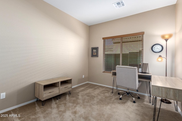 carpeted office space featuring baseboards and visible vents