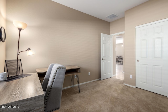 carpeted office featuring visible vents and baseboards