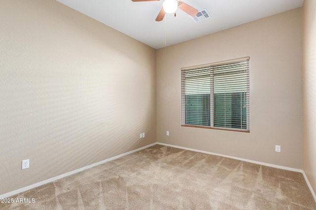 spare room with a ceiling fan, baseboards, visible vents, and carpet flooring