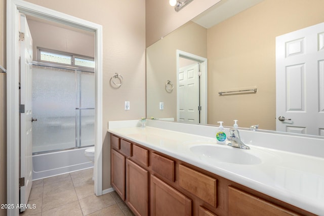 full bath featuring tile patterned flooring, shower / bath combination with glass door, vanity, and toilet