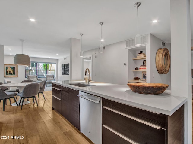 kitchen with open floor plan, a sink, dark brown cabinets, modern cabinets, and dishwasher