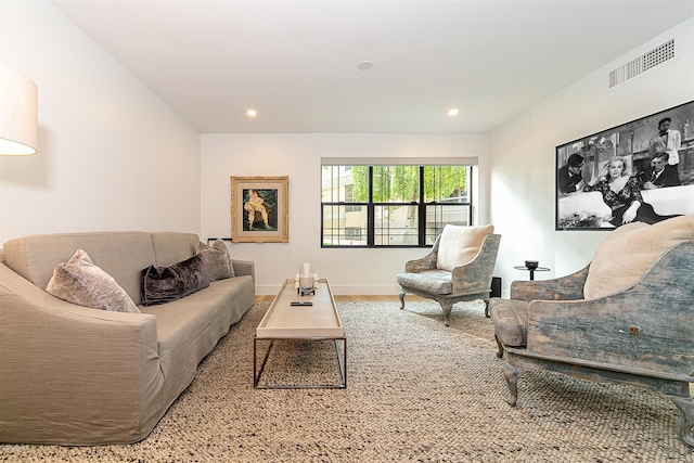 living room featuring baseboards, visible vents, and recessed lighting