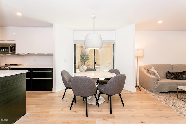 dining area with light hardwood / wood-style flooring