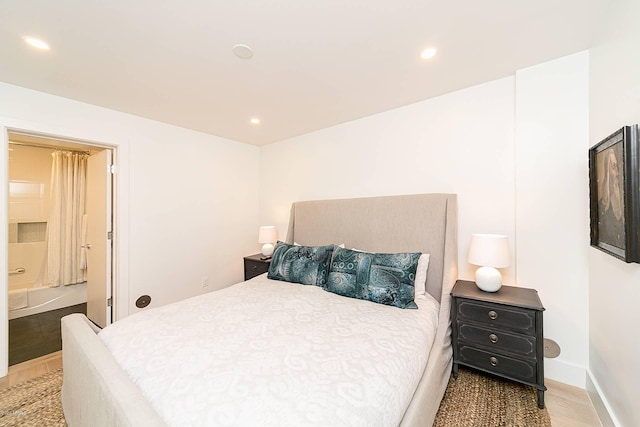 bedroom with light wood-style floors, baseboards, and recessed lighting