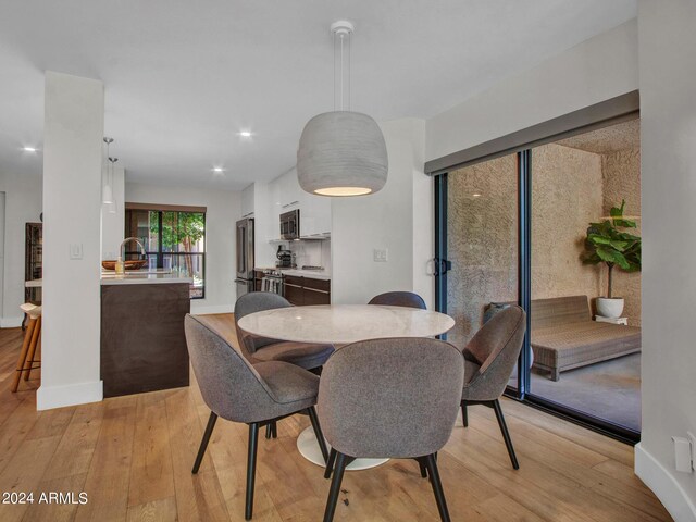 dining area featuring light hardwood / wood-style floors and sink