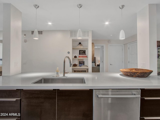 kitchen with stainless steel dishwasher, visible vents, dark brown cabinets, and a sink