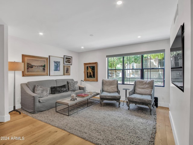 living room featuring recessed lighting, baseboards, and wood finished floors