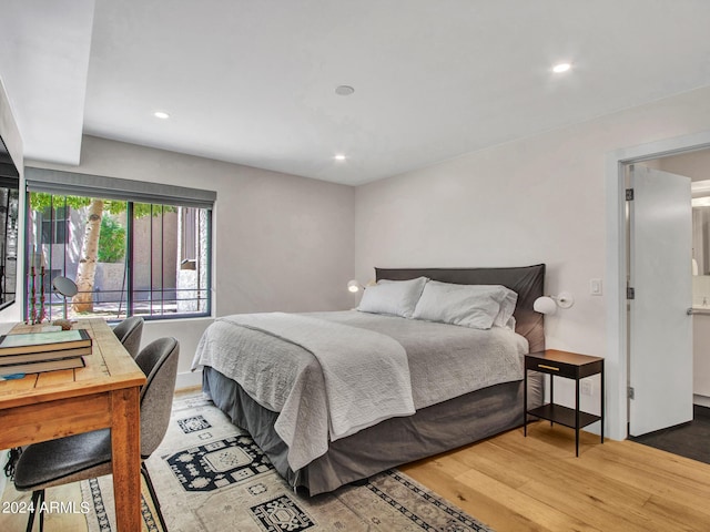 bedroom with recessed lighting and wood finished floors