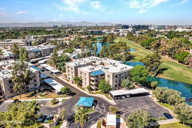 bird's eye view featuring a water view, a city view, and golf course view