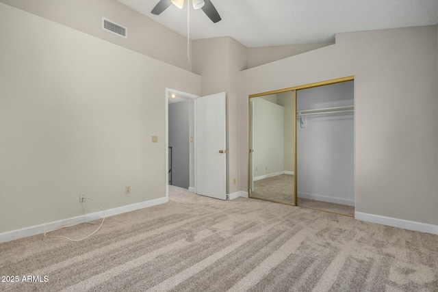 unfurnished bedroom featuring visible vents, baseboards, carpet flooring, and vaulted ceiling