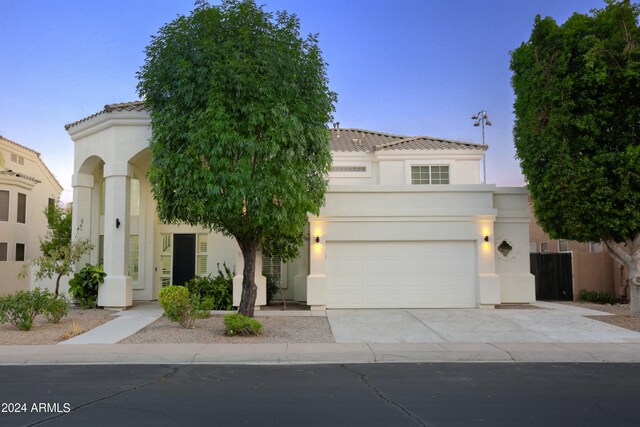 mediterranean / spanish home featuring a garage