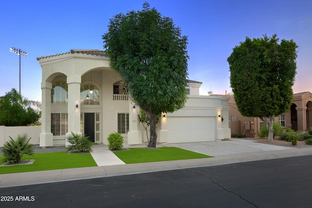 mediterranean / spanish-style house with a garage