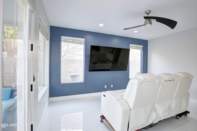 living area with tile patterned flooring and ceiling fan