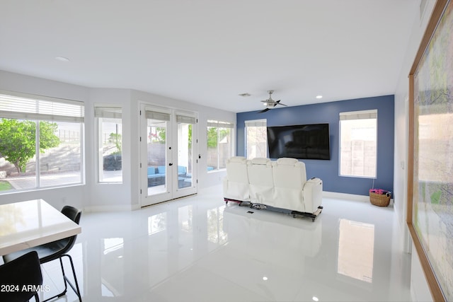 living room with tile patterned floors, french doors, and ceiling fan