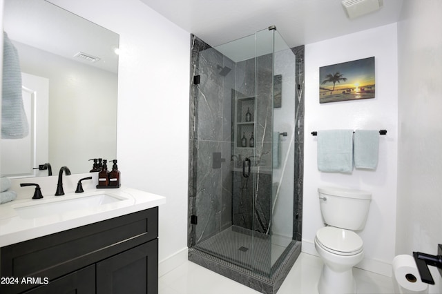 bathroom with vanity, a shower with shower door, tile patterned floors, and toilet