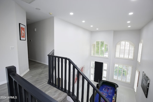 staircase with a healthy amount of sunlight and hardwood / wood-style floors