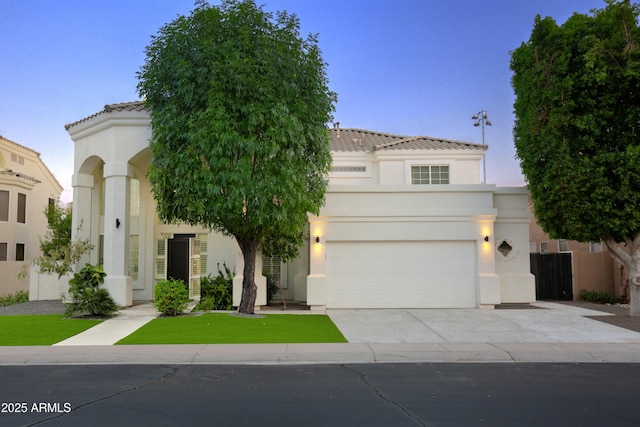 mediterranean / spanish home featuring a garage