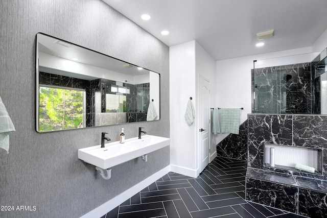 bathroom with walk in shower and dual sinks