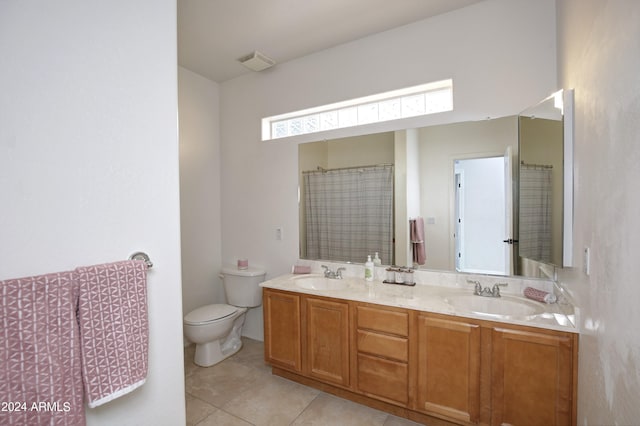 bathroom featuring tile patterned flooring, vanity, and toilet