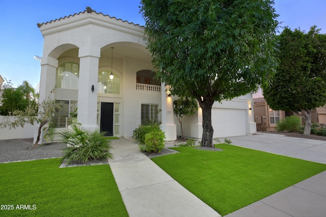 mediterranean / spanish home with a garage and a front yard