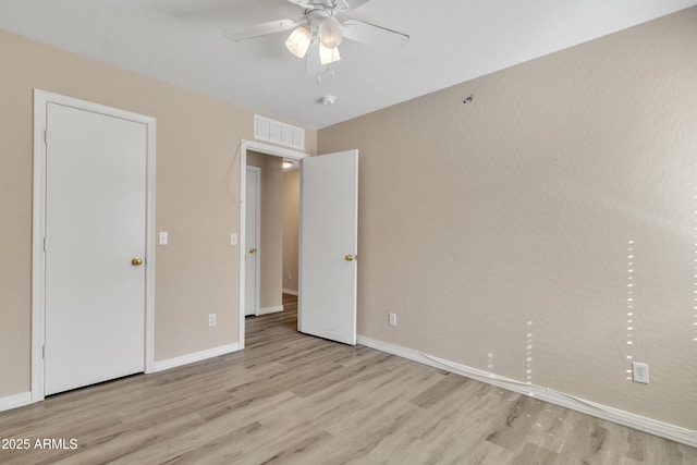 unfurnished bedroom with visible vents, baseboards, and light wood-style flooring