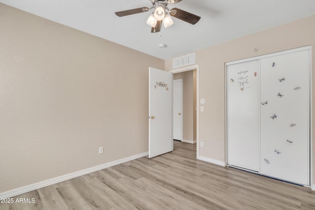 unfurnished bedroom featuring visible vents, baseboards, ceiling fan, and light wood finished floors