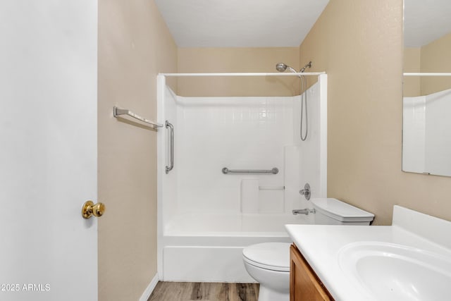 bathroom with toilet, vanity, bathing tub / shower combination, and wood finished floors