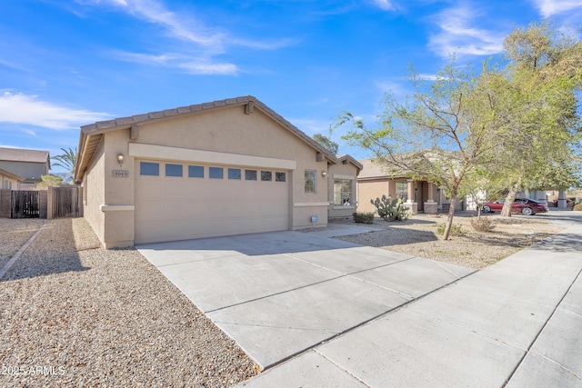 ranch-style house featuring stucco siding, a garage, concrete driveway, and fence