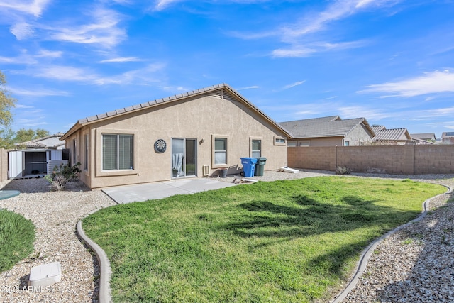 rear view of property featuring stucco siding, a patio, a lawn, and a fenced backyard