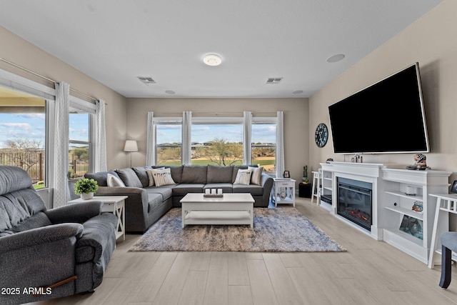 living room with a wealth of natural light and light wood-type flooring