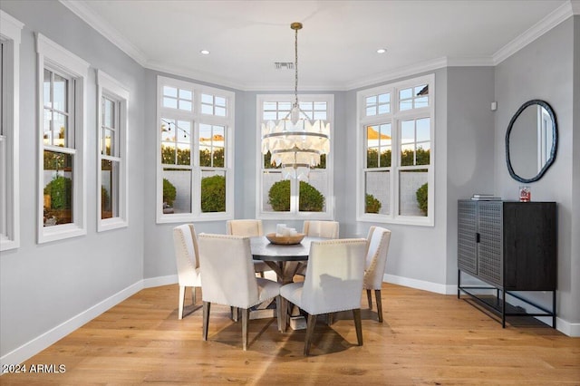 interior space with light wood-type flooring, ornamental molding, and a chandelier