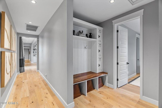 mudroom with light hardwood / wood-style flooring